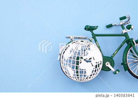 World bicycle day. Green bicycle with globe wheel promoting sustainable travel World bicycle day. Green bicycle with globe wheel promoting sustainable travel 140383841