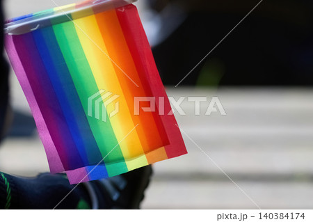 Holding rainbow flag representing lgbt pride and diversity Holding rainbow flag representing lgbt pride and diversity 140384174