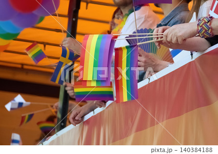 People holding rainbow flags celebrating pride parade 140384188