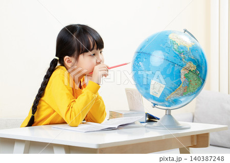 Asian little girl looking at globe, studying geography, focused child learning world map, education concept Asian little girl looking at globe, studying geography, focused child learning world map, education concept 140387248