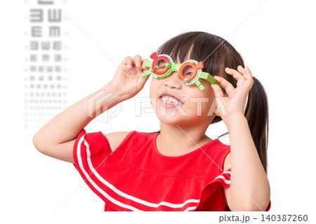Asian little girl eye test, covering one eye, vision examination, child healthcare, ophthalmology concept 140387260
