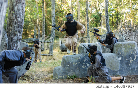 Attack of the paintball team on the enemy at army training ground 140387917