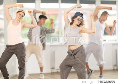 Young girl practicing basic hip hop moves in training hall 140388059
