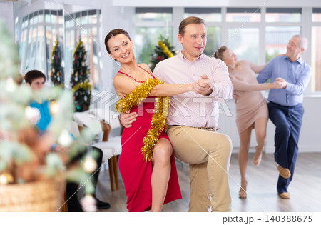 Lively adult couple dancing Lindy Hop at office New Year celebration Lively adult couple dancing Lindy Hop at office New Year celebration 140388675