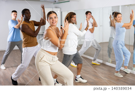 Group of different people rehearsing dance in dance studio 140389034