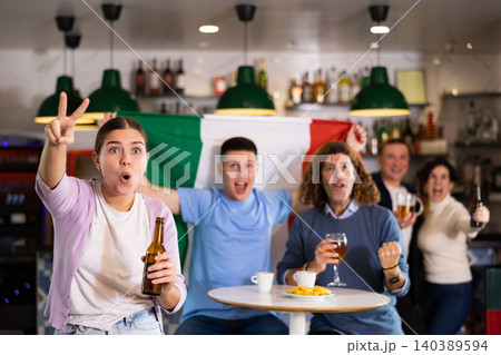 Happy fans celebrating the victory of Italian team in bar Happy fans celebrating the victory of Italian team in bar 140389594