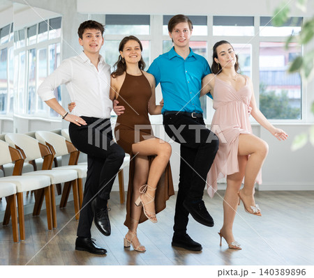 Cheerful young people performing Greek sirtaki in dance studio 140389896
