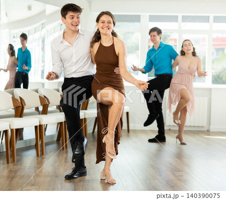 Enthusiastic young girl and guy rehearsing upbeat jive in dance studio Enthusiastic young girl and guy rehearsing upbeat jive in dance studio 140390075