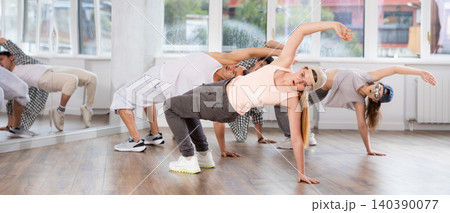Young girl practicing breakdance in training hall 140390077