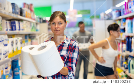 Young female shopper choosing paper towels in supermarket 140390258
