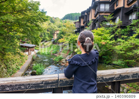 Young girl view ryokan hotel by river in Kurokawa onsen town, Kumamoto 140390809