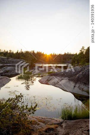 Nature skerry at Lake Ladoga in the Republic of Karelia in Russia against the background of the setting sun Nature skerry at Lake Ladoga in the Republic of Karelia in Russia against the background of the setting sun 140391936