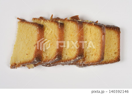 Slices of glazed lemon pound cake on white background Slices of glazed lemon pound cake on white background 140392146