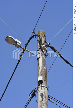Concrete Utility Pole with Street Light and Cables 140392175