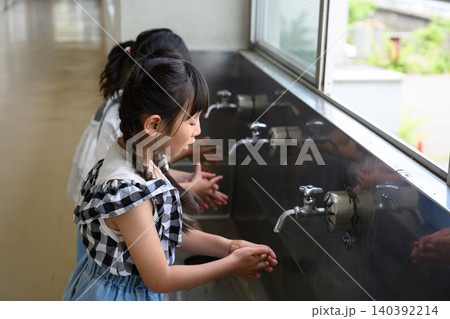 学校の水道場で丁寧に手を洗う女子小学生たち 学校の水道場で丁寧に手を洗う女子小学生たち 140392214