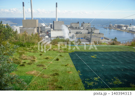 CopenHill innovative waste-to-energy power plant in Copenhagen that features a functioning artificial ski slope, hiking trails, and the world's tallest climbing wall on its roof 140394313