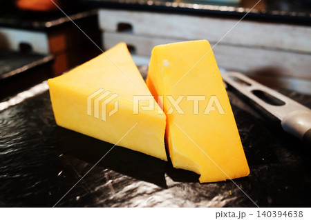 Two pieces of radamer cheese in black plate Two pieces of radamer cheese in black plate 140394638