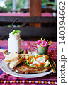 Pork chops steak with toast, french fries, creamy mayonnaise and fresh vegetables with fresh coconut milk shake 140394662