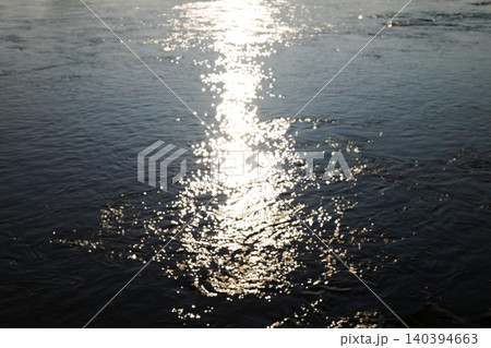 Beautiful light sparkling and shiny sunset in water sea surface 140394663