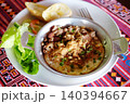 Top view of egg omelet and Minced pork in a frying pan with garlic bread and vegetables in white plate 140394667