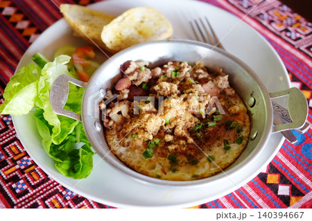 Top view of egg omelet and Minced pork in a frying pan with garlic bread and vegetables in white plate 140394667