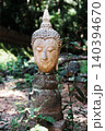 Ancient head of buddha statue in garden at Wat Umong is ancient temple in Chiang Mai of Thailand 140394670