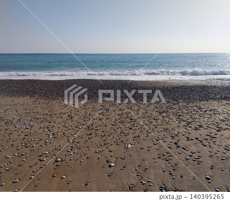 Mediterranean beach - blue water and pebbles Mediterranean beach - blue water and pebbles 140395265