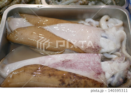Fresh pile squid cephalopods squirts mollusc ocean sea raw variety tentacles seafood display container freezer shelves shelf grocery store sale selling freshness food meat supermarket market stall Fresh pile squid cephalopods squirts mollusc ocean sea raw variety tentacles seafood display container freezer shelves shelf grocery store sale selling freshness food meat supermarket market stall 140395311