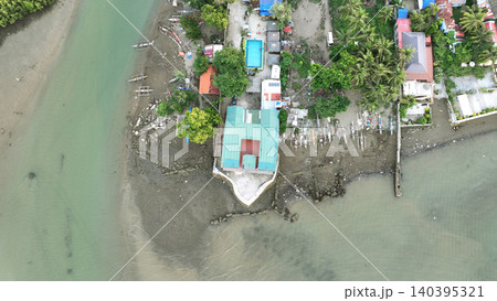 Residential and commercial resort sea Philippines Cebu low-lying river tidal flat zone hunasan ocean shoreline small fishing boat people volleyball docked beach fisherman livelihood coastal riverside 140395321