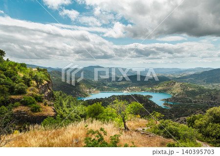 Mountain landscape with turquoise reservoir and rolling hills viewed from scenic overlook in Catalonia, Spain Mountain landscape with turquoise reservoir and rolling hills viewed from scenic overlook in Catalonia, Spain 140395703