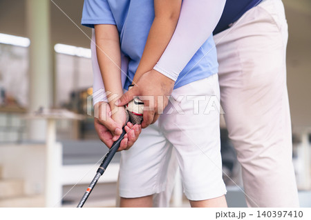 Close up of golf instructor teaching student how to grip club Close up of golf instructor teaching student how to grip club 140397410