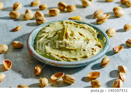 pistachio cream fills a rustic green bowl pistachio cream fills a rustic green bowl 140397431