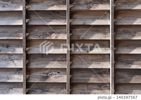 Old wooden fence with shadows and aged texture details Old wooden fence with shadows and aged texture details 140397567