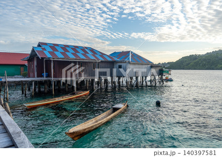 Fishermen houses and boats in Bajo village of Pulau Papan Sulawesi Indonesia Fishermen houses and boats in Bajo village of Pulau Papan Sulawesi Indonesia 140397581