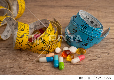 Measuring tape and tablet drug medical for diet. Measuring tape and tablet drug medical for diet. 140397905