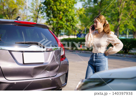 Woman calls insurance after two cars collide on road 140397938