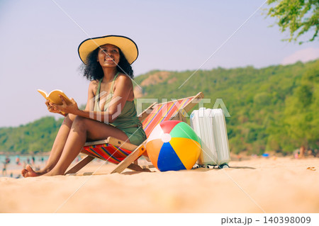 African Asian Woman Relaxing on Beach Chair and Reading Book 140398009