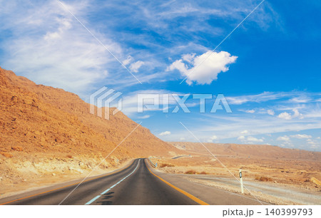 Driving a car in the desert in the early morning 140399793