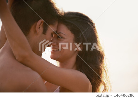 Love, smile and couple hugging with care on vacation, holiday or adventure together for romance. Happy, sunset and young man and woman embracing in nature on outdoor date on romantic weekend trip. Love, smile and couple hugging with care on vacation, holiday or adventure together for romance. Happy, sunset and young man and woman embracing in nature on outdoor date on romantic weekend trip. 140400290