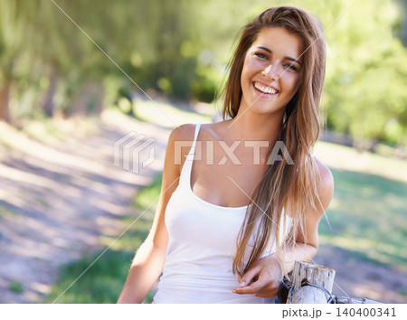 Portrait, woman or laugh for hair, fashion or summer in casual outfit with natural styling in park. Happy, female personl or tank top for stylish, fashionable or clothing in woods in New Zealand 140400341