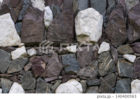 Ancient masonry wall built with natural gray river stones Ancient masonry wall built with natural gray river stones 140400563
