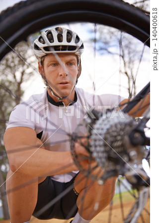 Face, wheel and repair with man cycling outdoor in nature for exercise, fitness or sports training. Bike, accident and young cyclist athlete fixing puncture of flat tyre for competition in forest Face, wheel and repair with man cycling outdoor in nature for exercise, fitness or sports training. Bike, accident and young cyclist athlete fixing puncture of flat tyre for competition in forest 140400618