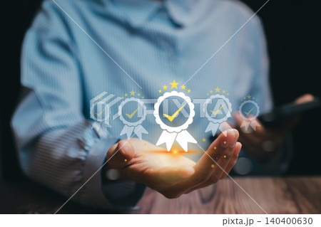 Quality assurance concept. Businessman holding virtual badge icons representing product certification, quality control, and standard assurance for corporate excellence. Quality assurance concept. Businessman holding virtual badge icons representing product certification, quality control, and standard assurance for corporate excellence. 140400630