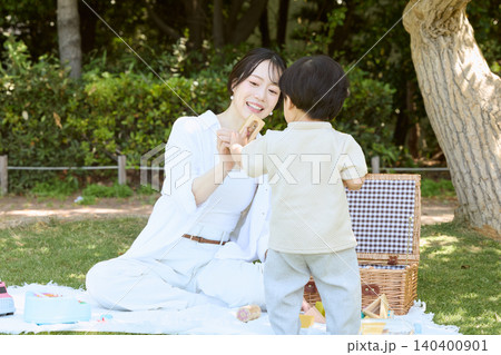 公園でピクニックを楽しむ母親と小さな男の子 公園でピクニックを楽しむ母親と小さな男の子 140400901