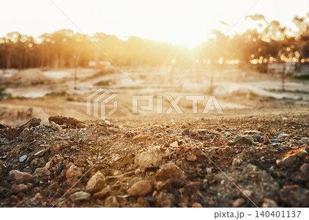 Sky, sunset and trees in nature with rocks in roadway for outdoor, countryside and lens flare. Landscape, dirt road and tough terrain for extreme sports, competition and sunshine in Switzerland. Sky, sunset and trees in nature with rocks in roadway for outdoor, countryside and lens flare. Landscape, dirt road and tough terrain for extreme sports, competition and sunshine in Switzerland. 140401137