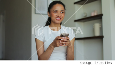 Portrait of a sporty woman resting at home after training and using her smartphone. Beautiful healthy sportive girl athlete resting after intense hard training. Portrait of a sporty woman resting at home after training and using her smartphone. Beautiful healthy sportive girl athlete resting after intense hard training. 140401165