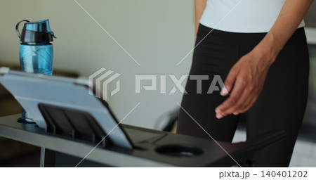 Close up workout, woman and walking on treadmill in home for cardio exercise, fitness challenge and burning calories. Close up workout, woman and walking on treadmill in home for cardio exercise, fitness challenge and burning calories. 140401202