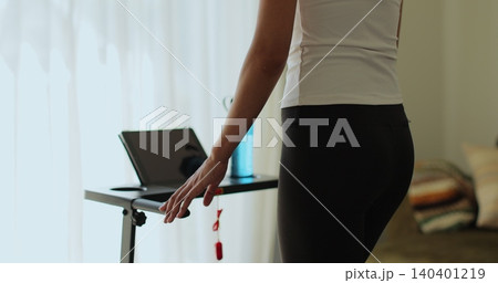 Back view. Fitness, girl and walking on treadmill in home for cardio exercise, wellness challenge and burning calories. Back view. Fitness, girl and walking on treadmill in home for cardio exercise, wellness challenge and burning calories. 140401219