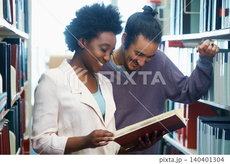 Man, woman and friends at library or reading book together as students for education, research or learning. University, pupils and literature in USA college for degree exam, collaboration or test Man, woman and friends at library or reading book together as students for education, research or learning. University, pupils and literature in USA college for degree exam, collaboration or test 140401304