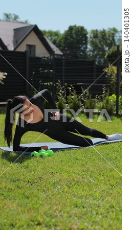 Vertical video. Young woman doing sports at nature, Female fitness training in sportswear. Sport, fitness, health and lifestyle concept. Vertical video. Young woman doing sports at nature, Female fitness training in sportswear. Sport, fitness, health and lifestyle concept. 140401305